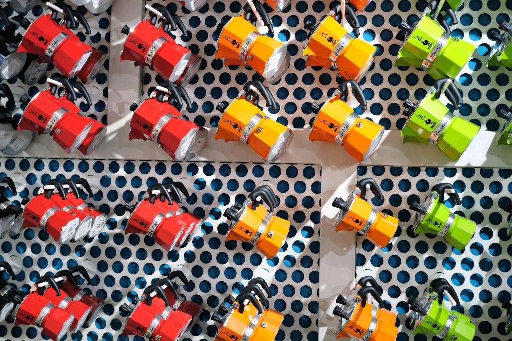 colorful italian moka pots coffee makers hanging on the wall in a shop in Venice